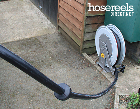 Compact hose reel with a large bore hose being used for volume delivery of diesel