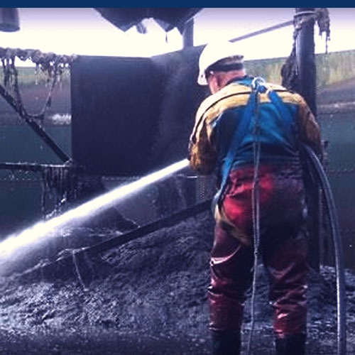 Operator using hose reel at a water treatment plant
